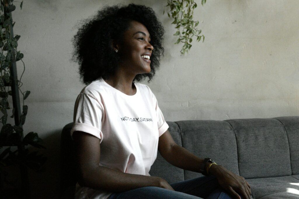 woman smiling sitting on sofa